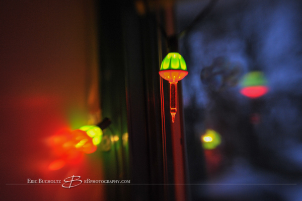 Lensbaby tilt shift manual focus lens image, warm incandescent bubble lights and blue morning light hues closeup