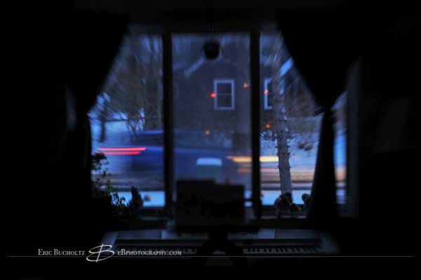 Lensbaby tilt shift manual focus lens image, slow shutter motion blur of traffic and blue morning light hues