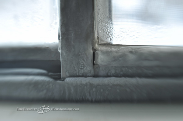 Lensbaby tilt shift manual focus lens image, ice buildup on old window frame